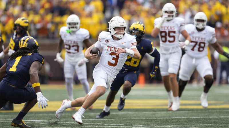 Texas quarterback Quinn Ewers (3) runs the ball against Michigan in the first half of an NCAA college football game in Ann Arbor, Mich., Saturday, Sept. 7, 2024. (AP Photo/Paul Sancya)