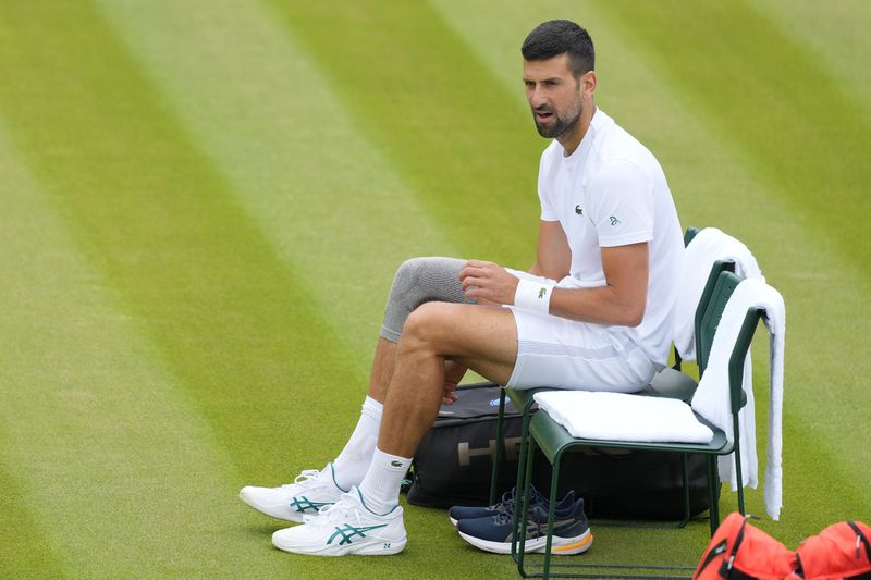 Novak Djokovic of Serbia sits in his chair during a training session on Court 2 at the All England Lawn Tennis and Croquet Club in Wimbledon, London, Friday, June 28, 2024. The Wimbledon Championships begin on July 1. (AP Photo/Kirsty Wigglesworth)