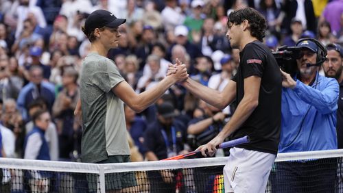 Jannik Sinner, left, of Italy, greets Taylor Fritz, of the United States, after winning the men's singles final of the U.S. Open tennis championships, Sunday, Sept. 8, in New York. 2024. (AP Photo/Seth Wenig)