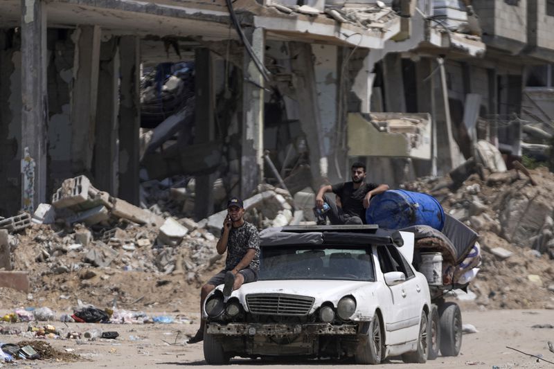 Palestinians evacuate Maghazi refugee camp in the central Gaza Strip, as part of a mass evacuation ordered by the Israeli military ahead of an operation, Saturday, Aug. 17, 2024. (AP Photo/Abdel Kareem Hana)