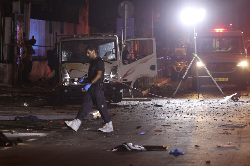 Israeli police work at the scene of a bomb explosion in Tel Aviv, Israel, Sunday, Aug. 18, 2024. Israeli police say one person was killed and another moderately injured. (AP Photo/Moti Milrod)