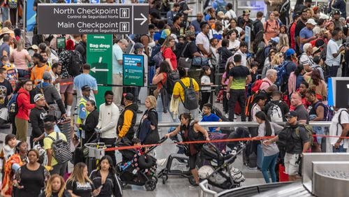 Travelers at Hartsfield-Jackson International Airport crowd around ticket counters on July 19, as a massive outage triggered by a security update from CrowdStrike affected Microsoft users around the globe, disrupting airlines, railways, banks, stock exchanges and other businesses. (John Spink/AJC 2024)