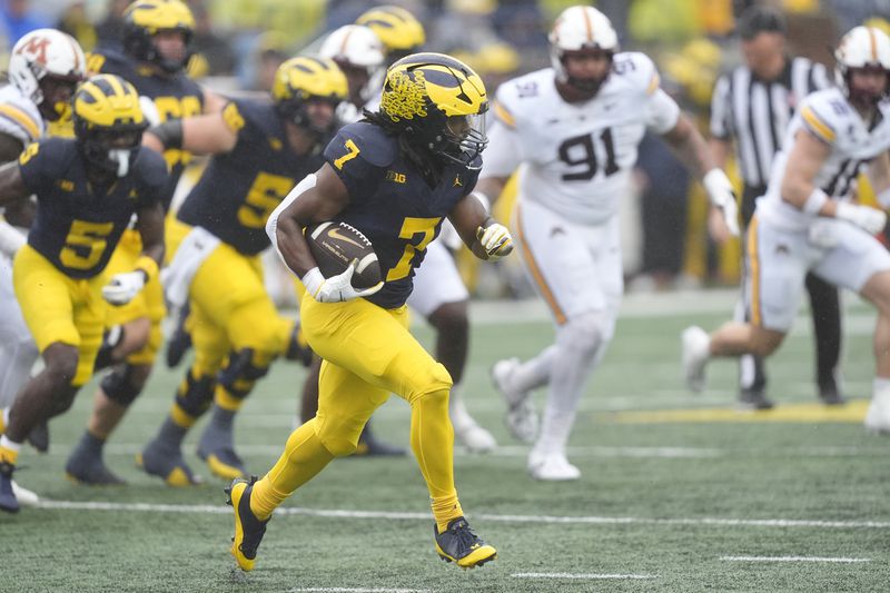 Michigan running back Donovan Edwards (7) rushes during the first half of an NCAA college football game Minnesota, Saturday, Sept. 28, 2024, in Ann Arbor, Mich. (AP Photo/Carlos Osorio)