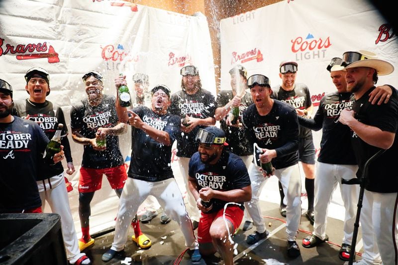 Braves players celebrate with champagne after clinching their spot in the postseason.