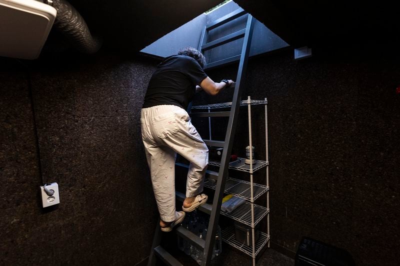 Jung Myungja, 73, climbs up the steps of a small bunker dug into the yard of her home in Seoul, Tuesday, May 28, 2024. (AP Photo/Jae C. Hong)