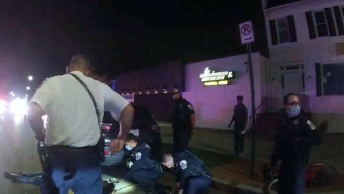 This Metropolitan Police Department police-worn body cam image from video, contained in the Justice Department's sentencing memorandum, shows Karon Hylton-Brown, 20, on the ground, after a moped chase on Oct. 23, 2020, in Washington. (Department of Justice via AP)