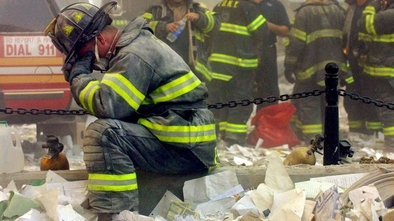 A firefighter breaks down after the World Trade Center buildings collapsed September 11, 2001 after two hijacked airplanes slammed into the twin towers in a terrorist attack.