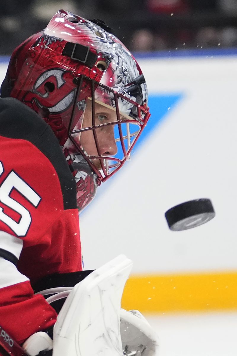 New Jersey goaltender Devils' Jacob Markstrom watches the puck during the NHL hockey game between Buffalo Sabres and New Jersey Devils, in Prague, Czech Republic, Friday, Oct. 4, 2024. (AP Photo/Petr David Josek)