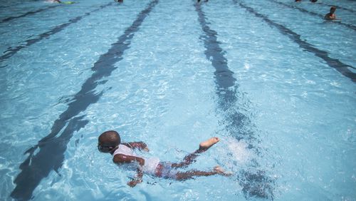 FILE - Children cool off at the Hamilton Fish pool, July 18, 2017, in the Lower East Side neighborhood of Manhattan. In most cases, there’s no need to wait at least 30 minutes after eating to go for a swim, doctors say. (AP Photo/Mary Altaffer, File)