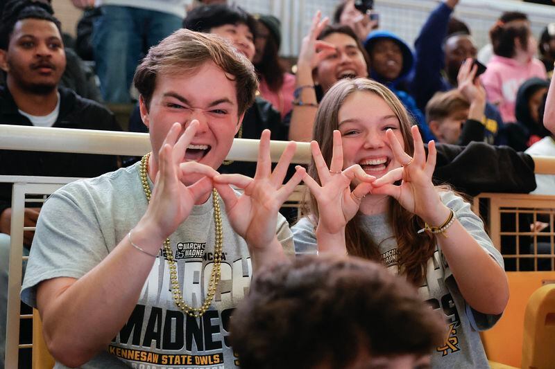 Kennesaw State freshmen Joey Van Sickle and Samantha Calmes hold up the Owl Eyes sign at the KSU Convocation Center during the basketball team’s first appearance in the NCAA tournament on Friday, March 17, 2023.  (Natrice Miller/ natrice.miller@ajc.com)
