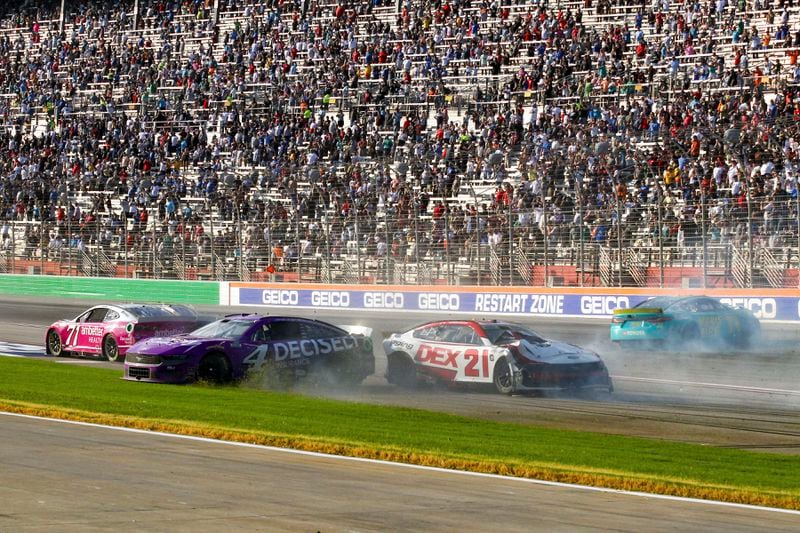 Josh Berry (4), Zane Smith (71), Harrison Burton (21) and Denny Hamlin (11) are involved in a wreck while coming out of Turn 4 during a NASCAR Cup Series auto race Sunday, Sept. 8, 2024, in Hampton, Ga. (AP Photo/Skip Williams)