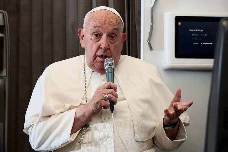 Pope Francis holds a news conference aboard the papal plane on his flight back after his 12-day journey across Southeast Asia and Oceania, Friday, Sept. 13, 2024. (Guglielmo Mangiapane/Pool Photo via AP)