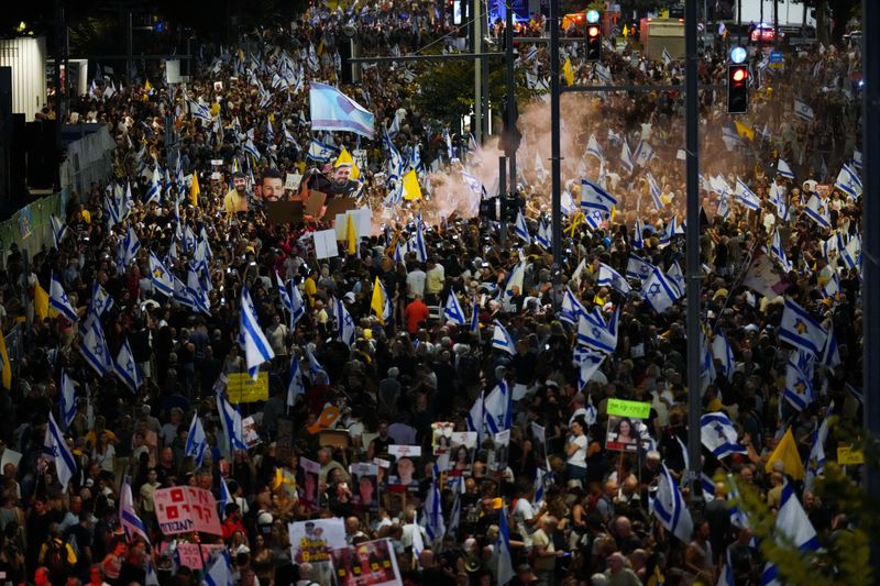 People protest against Prime Minister Benjamin Netanyahu's government and call for the release of hostages held in the Gaza Strip by the Hamas militant group, in Tel Aviv, Israel, Saturday, Sept. 7, 2024. (AP Photo/Ariel Schalit)