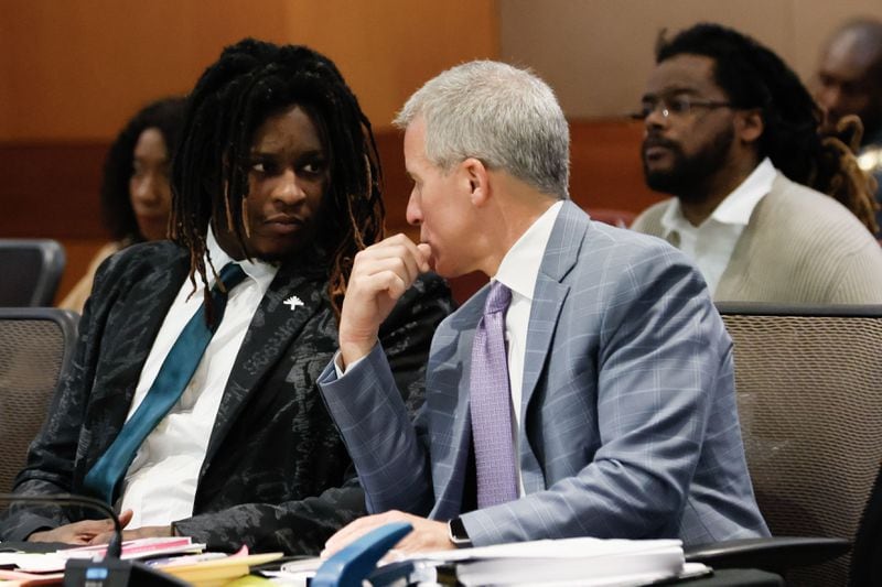 Young Thug (left, birth name Jeffery Williams) speaks with attorney Brian Steel.