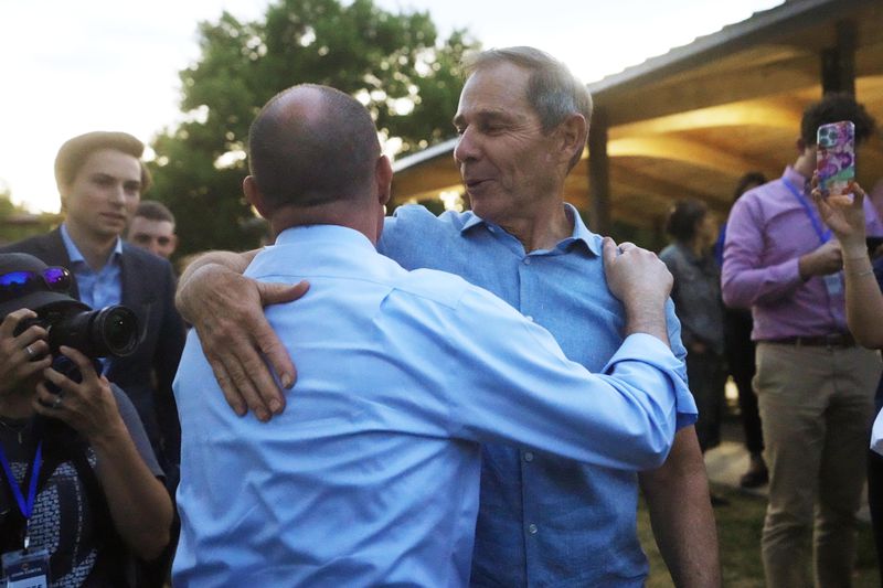 U.S. Sen. Mike Lee, left, hugs U.S. Rep. John Curtis following his win during an election night party Tuesday, June 25, 2024, in Provo, Utah. Curtis has won the Utah GOP primary for Mitt Romney's open U.S. Senate seat, defeating one opponent who was endorsed by former President Donald Trump and others who said they supported Trump's agenda. (AP Photo/Rick Bowmer)