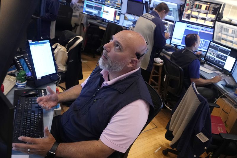 Trader Vincent Napolitano, left, works with colleagues on the floor of the New York Stock Exchange, Friday, Aug. 16, 2024. (AP Photo/Richard Drew)