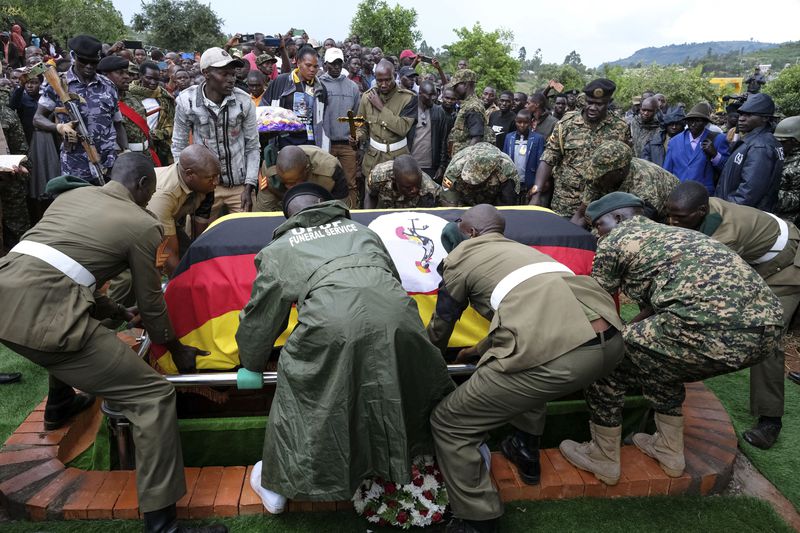 Members of the Uganda People's Defense Force lower the casket of Ugandan Olympic athlete Rebecca Cheptegei into the grave in Kapkoros, Bukwo District, Uganda, on Saturday, Sept. 14. 2024. (AP Photo/Hajarah Nalwadda)