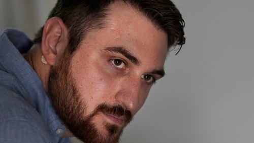 Cancer patient Steven Manetta sits for a portrait Thursday, Aug. 29, 2024, in his Lemont, Ill., home where he takes at least a dozen pills daily to keep a form of the blood cancer leukemia in remission. (AP Photo/Charles Rex Arbogast)