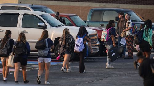 Students arrive at Apalachee High School, after the school reopened almost three weeks after a deadly shooting on campus, Tuesday, Sept. 24, 2024, in Winder, Ga. (AP Photo/Mike Stewart)