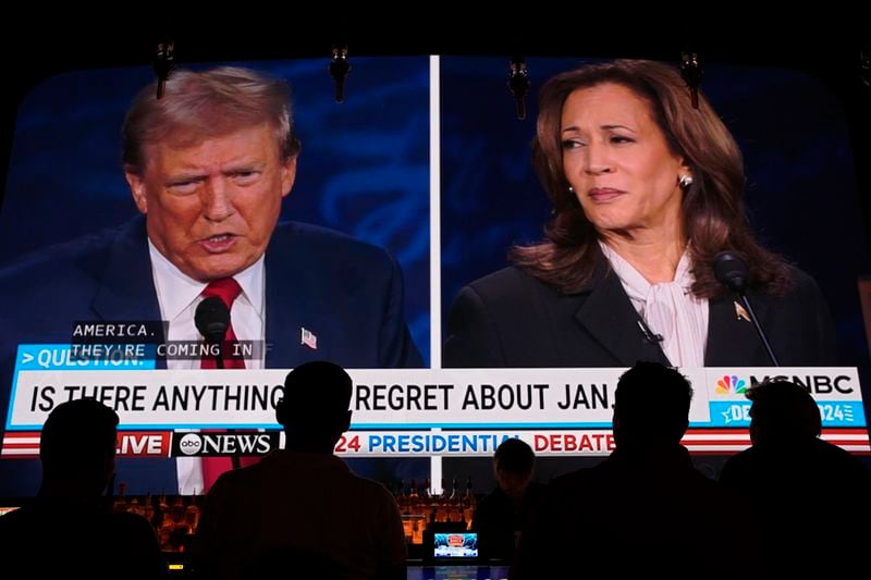 People watch the presidential debate between Republican presidential nominee former President Donald Trump and Democratic presidential nominee Vice President Kamala Harris, Tuesday, Sept. 10, 2024, at the Gipsy Las Vegas in Las Vegas. (AP Photo/John Locher)