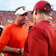 Auburn head coach Hugh Freeze, left, and Oklahoma head coach Brent Venables, right, meet at midfield after the second half of an NCAA college football game, Saturday, Sept. 28, 2024, in Auburn, Ala. (AP Photo/Butch Dill)