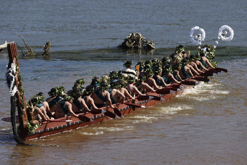 A waka, a traditional canoe, is paddled by warriors on the Waikato River as part of the funeral of New Zealand's Maori King, Kiingi Tuheitia Pootatau Te Wherowhero VII, in Ngaruawahia, New Zealand, Thursday, Sept. 5, 2024. (AP Photo/Alan Gibson)