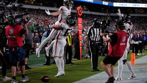 Atlanta Falcons wide receiver Drake London (5) celebrates his touchdown with teammate Chris Lindstrom (63) during the second half of an NFL football game against the Philadelphia Eagles on Monday, Sept. 16, 2024, in Philadelphia. (AP Photo/Matt Rourke)