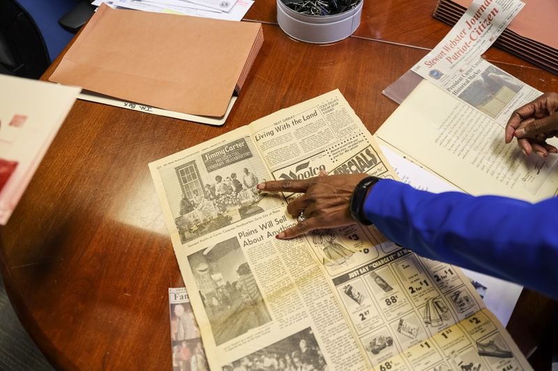 Bernstine W. Hollis displays newspaper clippings she’s collected over the years at the Carter Center in Atlanta on Tuesday, August 23, 2022. Hollis is one of the center’s first employees, and her history with the Carters stretches back to her childhood in Plains. (Arvin Temkar / arvin.temkar@ajc.com)