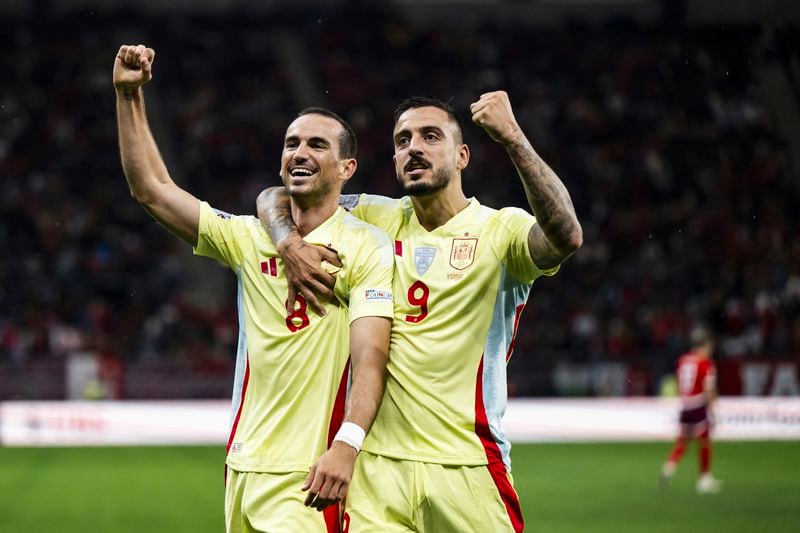 Spain's midfielder Fabian Ruiz, left, celebrates after scoring the second goal with Spain's forward Joselu, right, during the Nations League group A4 qualifying soccer match between Switzerland and Spain, at the Stade de Geneve, in Geneva, Switzerland, Sunday, Sept. 8, 2024. (Jean-Christophe Bott/Keystone via AP)