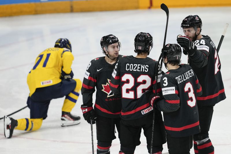 Canada's Dylan Cozens celebrates with teammates after scoring his side's opening goal during the bronze medal match between Sweden and Canada at the Ice Hockey World Championships in Prague, Czech Republic, Sunday, May 26, 2024. (AP Photo/Darko Vojinovic)