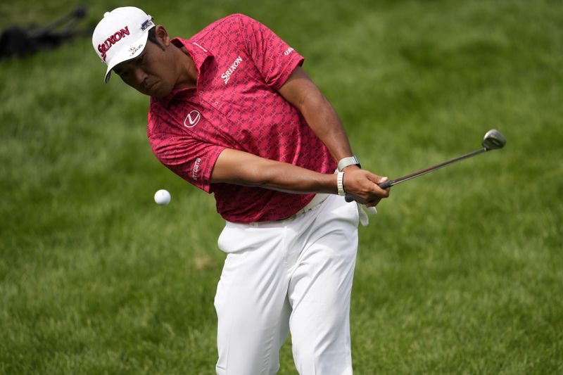 Hideki Matsuyama, of Japan, chips onto the 17th green during the first round of the BMW Championship golf event at Castle Pines Golf Club, Thursday, Aug. 22, 2024, in Castle Rock, Colo. (AP Photo/Matt York)