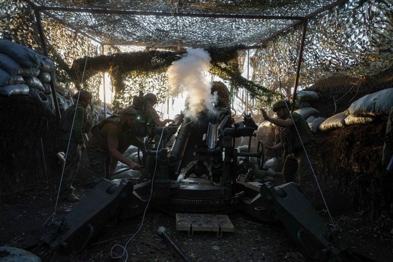 Ukrainian servicemen of 148th separate artillery brigade of the Air Assault Forces fire towards Russian positions by a M777 howitzer at the frontline in Donetsk region, Ukraine, Wednesday, August 21, 2024. (AP Photo/Evgeniy Maloletka)