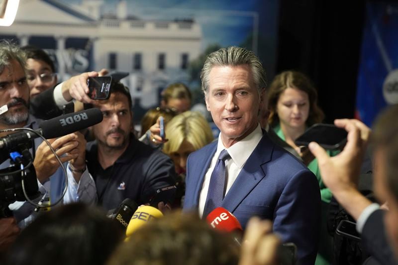 California Gov. Gavin Newsom speaks to reporters in the spin room before a presidential debate between Republican presidential nominee former President Donald Trump and Democratic presidential nominee Vice President Kamala Harris, Tuesday, Sept. 10, 2024, in Philadelphia. (AP Photo/Matt Rourke)