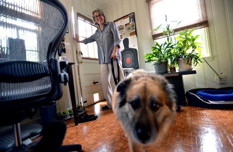 Amanda Kyle Williams prepares to go out to her backyard with her dog Brando in Decatur. HYOSUB SHIN / HSHIN@AJC.COM