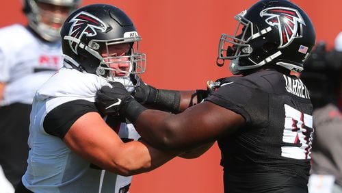 Falcons offensive lineman Chris Lindstrom (left) and defensive lineman Grady Jarrett face off at the line of scrimmage on the fourth day of training camp practice on Sunday, Aug. 1, 2021, in Flowery Branch. (Curtis Compton / Curtis.Compton@ajc.com)