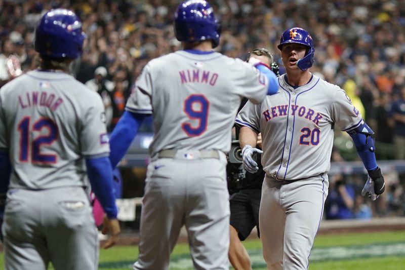 New York Mets' Pete Alonso celebrates his three-run home run with Brandon Nimmo (9) and Francisco Lindor (12) during the ninth inning of Game 3 of a National League wild card baseball game against the Milwaukee Brewers Thursday, Oct. 3, 2024, in Milwaukee. (AP Photo/Morry Gash)