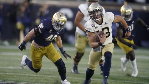 Georgia Tech quarterback Jordan Yates (13) is chased by Notre Dame's Drew White (40) during the second half of an NCAA college football game, Saturday, Nov. 20, 2021, in South Bend, Ind. Notre Dame won 55-0. (AP Photo/Darron Cummings)