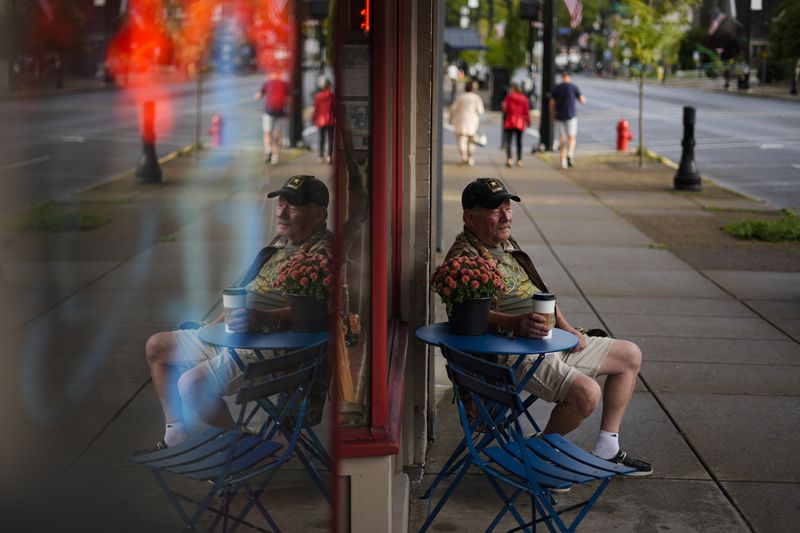 Jim Perry who witnessed an assassination attempt against Republican presidential nominee former President Donald Trump, plans to attend an upcoming rally, sits outside Cummings Candy & Coffee in Butler, Saturday, Sept. 28, 2024. (AP Photo/Matt Rourke)