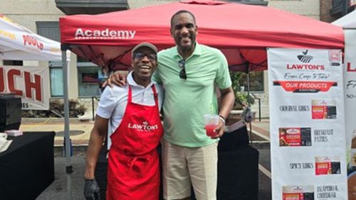 Andrew Lawton (left), seen here with former Atlanta Hawks player Steve Smith, sells his sausages at local farmers markets. (Courtesy of Lawton Sausage Co.)