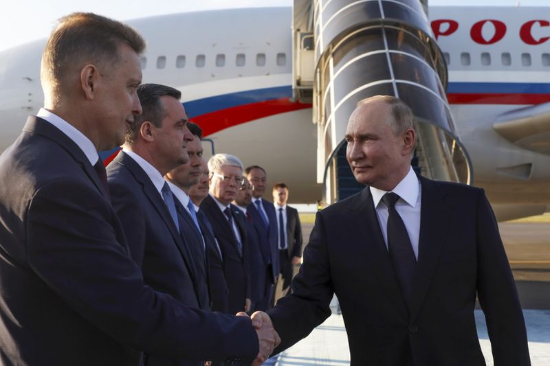 Russian President Vladimir Putin shakes hands with diplomats upon his arrival at the international airport in Astana, Kazakhstan, Wednesday, July 3, 2024. (Gavriil Grigorov, Sputnik, Kremlin Pool Photo via AP)