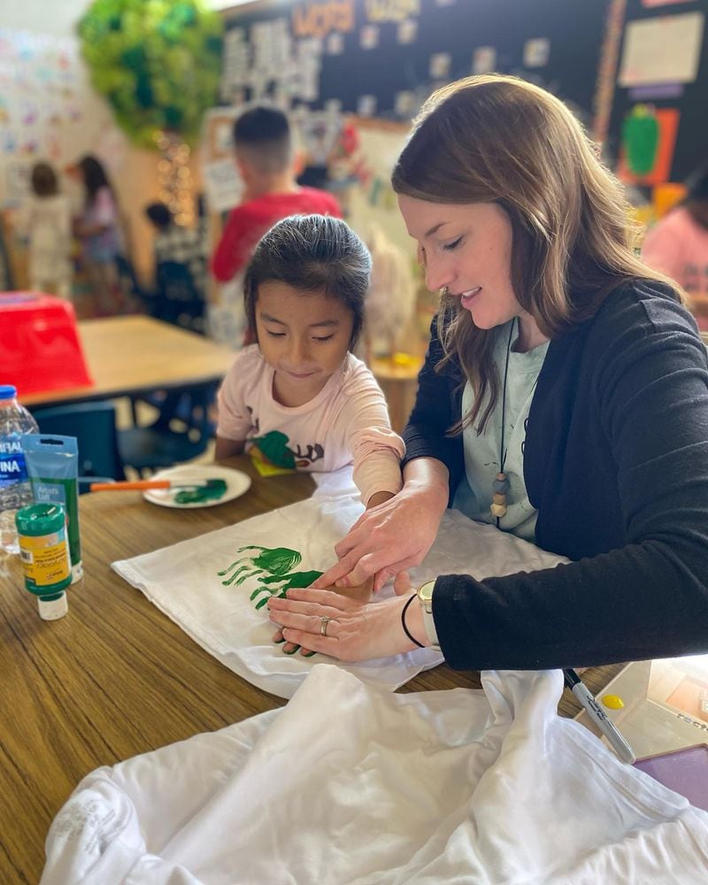Pre-K 2022-2023 Teacher of the Year Shannon Gibson from Baldwin Elementary School works with a student on an art project. Gibson is the public school winner.