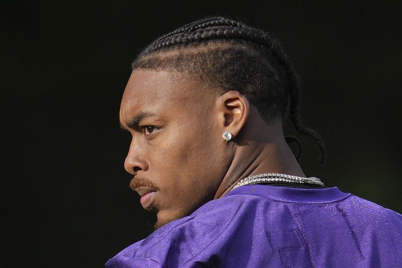 Minnesota Vikings wide receiver Justin Jefferson (18) looks on during NFL football practice at The Grove in Watford, England Friday, Oct. 4, 2024. (AP Photo/Kin Cheung)