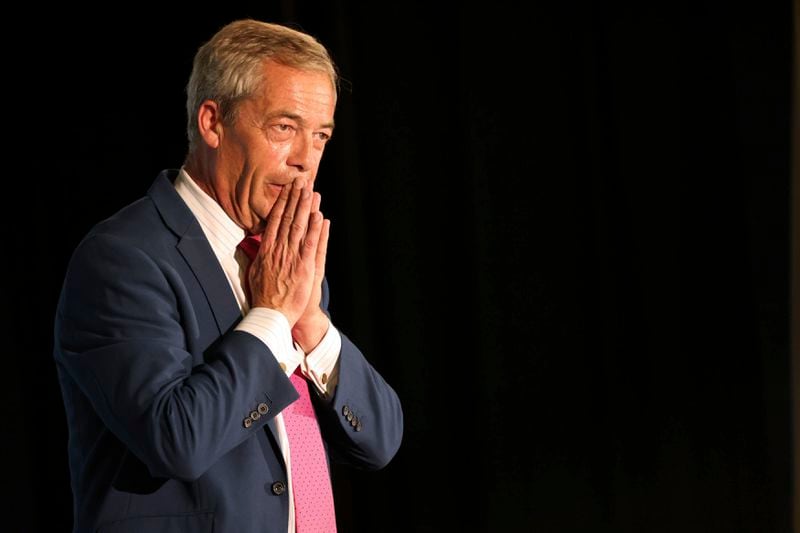 Reform UK Leader Nigel Farage gestures during a meeting while on the general election campaign trail, in Boston, England, Thursday June 27, 2024. (Paul Marriott/PA via AP)