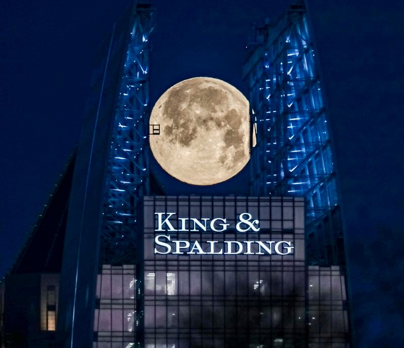 March 7, 2023 Atlanta: The full Worm Moon reached its peak illumination Tuesday morning March 7, 2023 seen here sandwiched between the two glass fins extending upwards from the north and south walls of the 657 foot tall 1180 Peachtree building, also known as Symphony Tower in midtown Atlanta. (John Spink / John.Spink@ajc.com)

