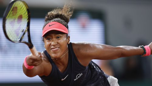 Japan's Naomi Osaka plays a shot against Poland's Iga Swiatek during their second round match of the French Open tennis tournament at the Roland Garros stadium in Paris, Wednesday, May 29, 2024. (AP Photo/Jean-Francois Badias)