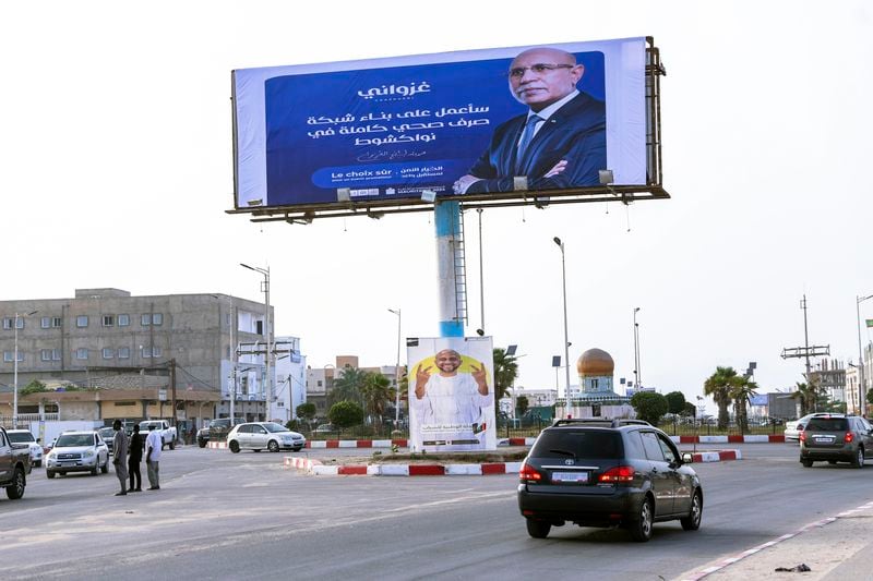 An electoral banner for Mauritanian president Mohamed Ould Ghazouani, is seen ahead of the presidential elections in Nouakchott, Mauritania, Tuesday, June 25, 2024. Banner in Arabic reads "I will work on building a complete sewage network in Nouakchott." (AP Photo/Mamsy Elkeihel)