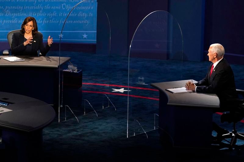 FILE - Democratic vice presidential candidate Sen. Kamala Harris, D-Calif., left, speaks as Vice President Mike Pence listens during the vice presidential debate Oct. 7, 2020, in Salt Lake City. (AP Photo/Julio Cortez, File)