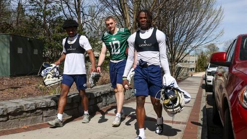 Georgia Tech quarterback Haynes King, center, walks with wide receivers Malik Rutherford, left, and Eric Singleton, Jr. as they head back to Bobby Dodd Stadium following their first day of spring football practice, Monday, March 11, 2024, in Atlanta. (Jason Getz / jason.getz@ajc.com)