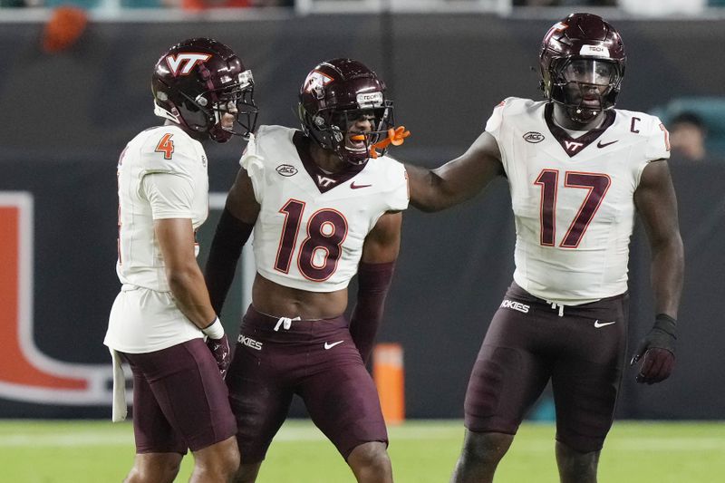 Virginia Tech safety Mose Phillips III (18) celebrates intercepting a pass during the first half of an NCAA college football game against Miami, Friday, Sept. 27, 2024, in Miami Gardens, Fla. (AP Photo/Marta Lavandier)