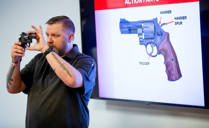 Instructor Kyle Klyncko goes over revolvers during a Saturday morning handgun training class at Georgia Gun Club in Buford in January.  STEVE SCHAEFER FOR THE ATLANTA JOURNAL-CONSTITUTION